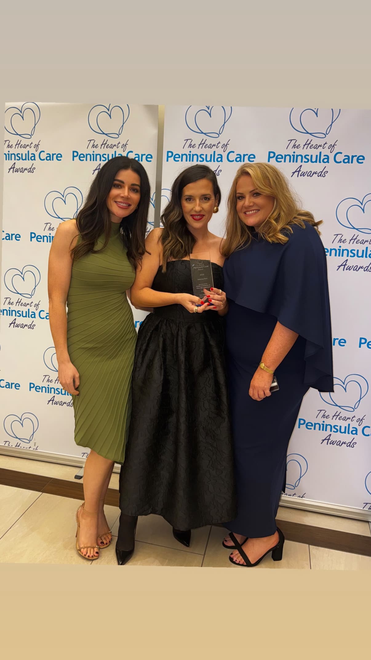 Vera Ribeiro with colleagues, holding the Unsung Hero Award